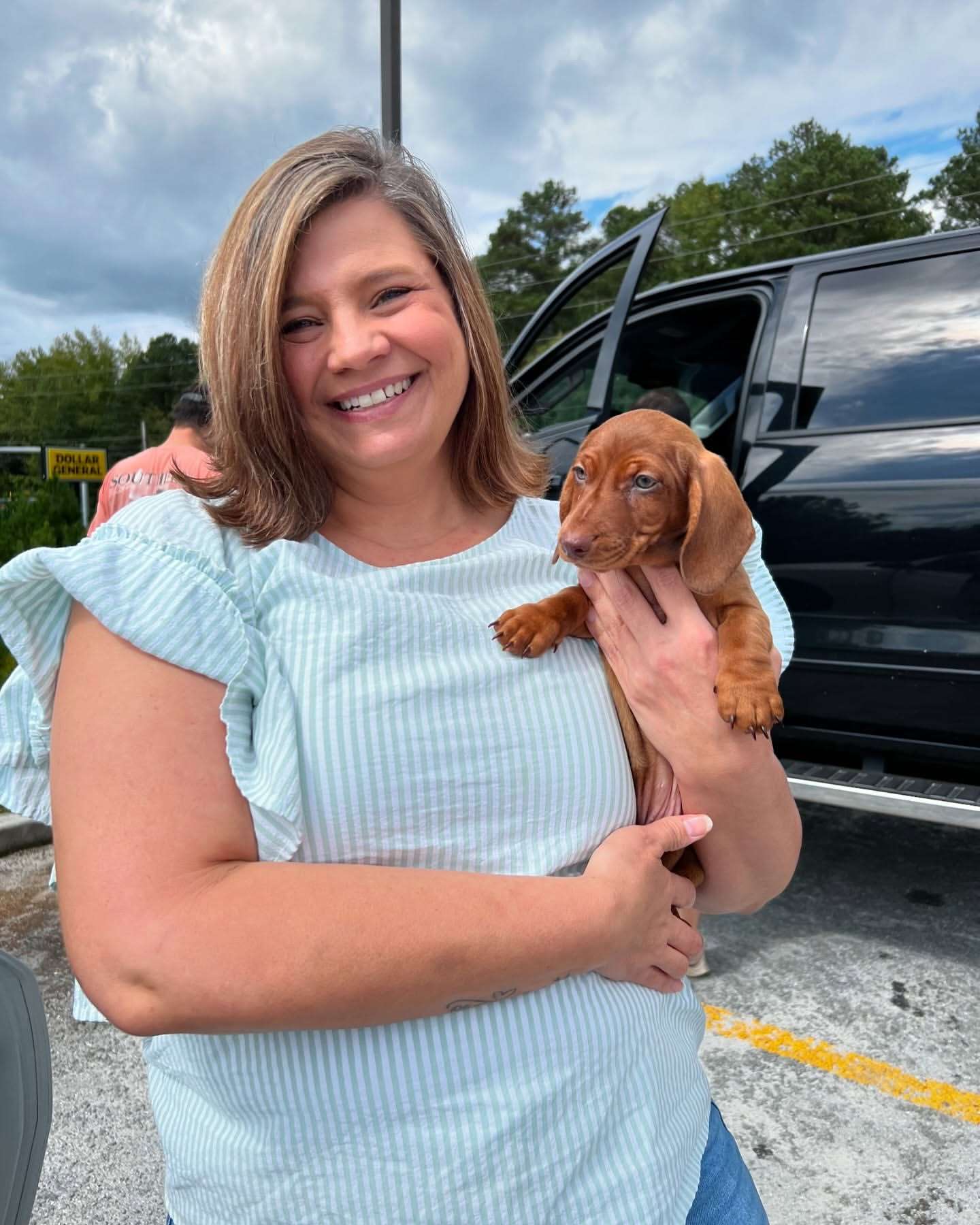 Happy family with their Dachshund puppy