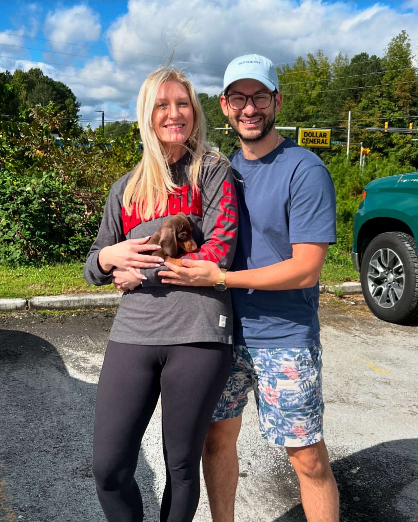 Happy family with their Dachshund puppy