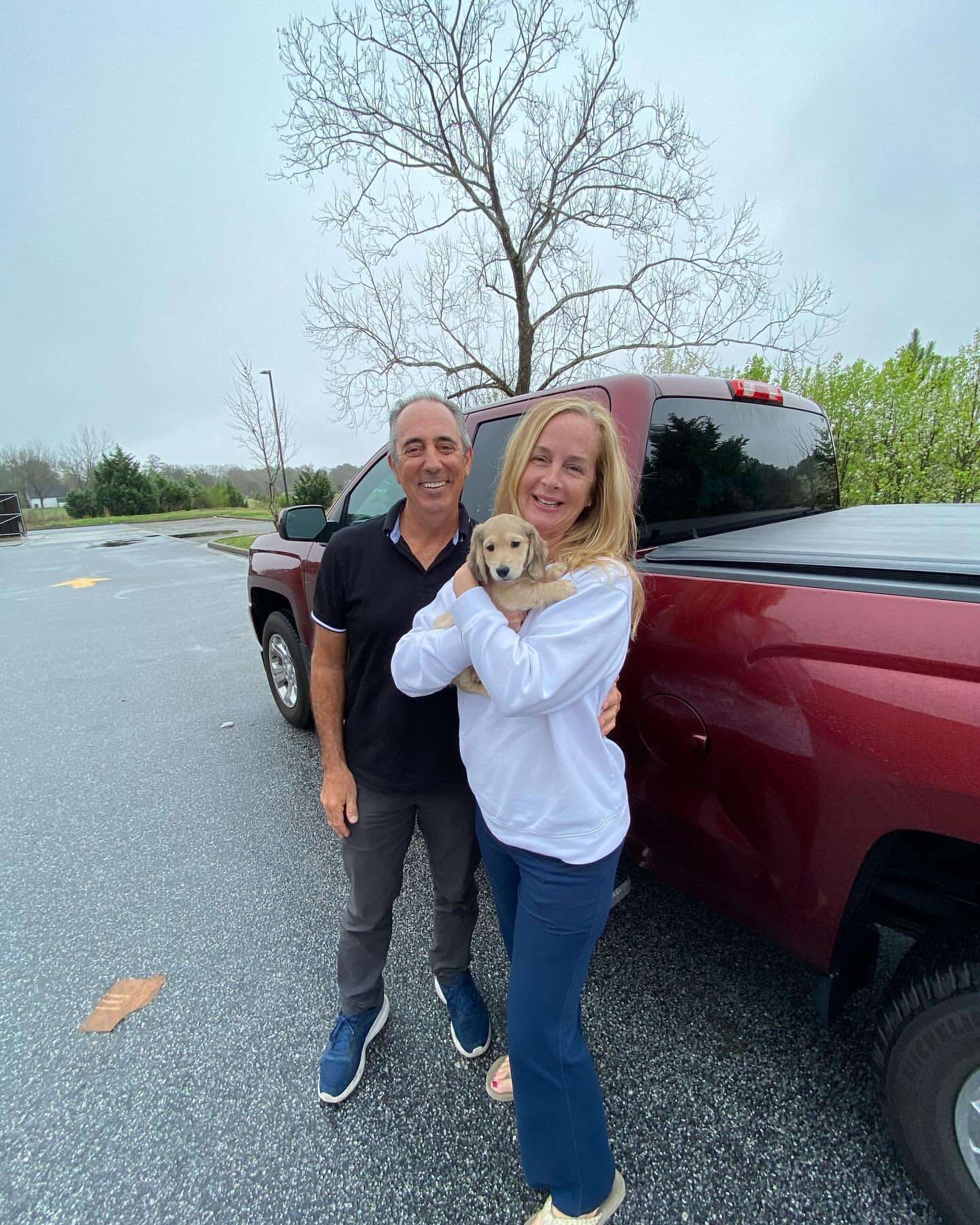 Happy family with their Dachshund puppy