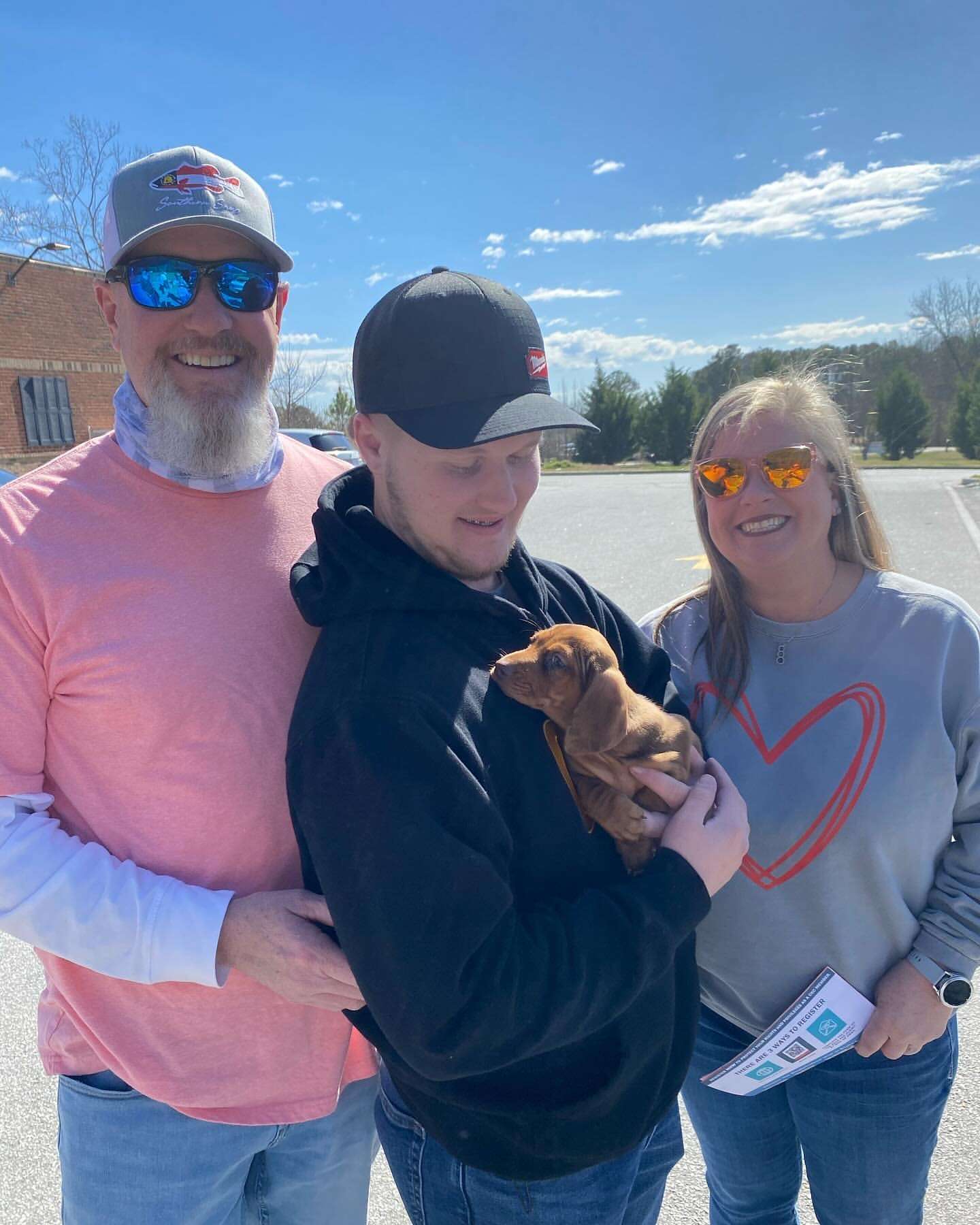 Happy family with their Dachshund puppy