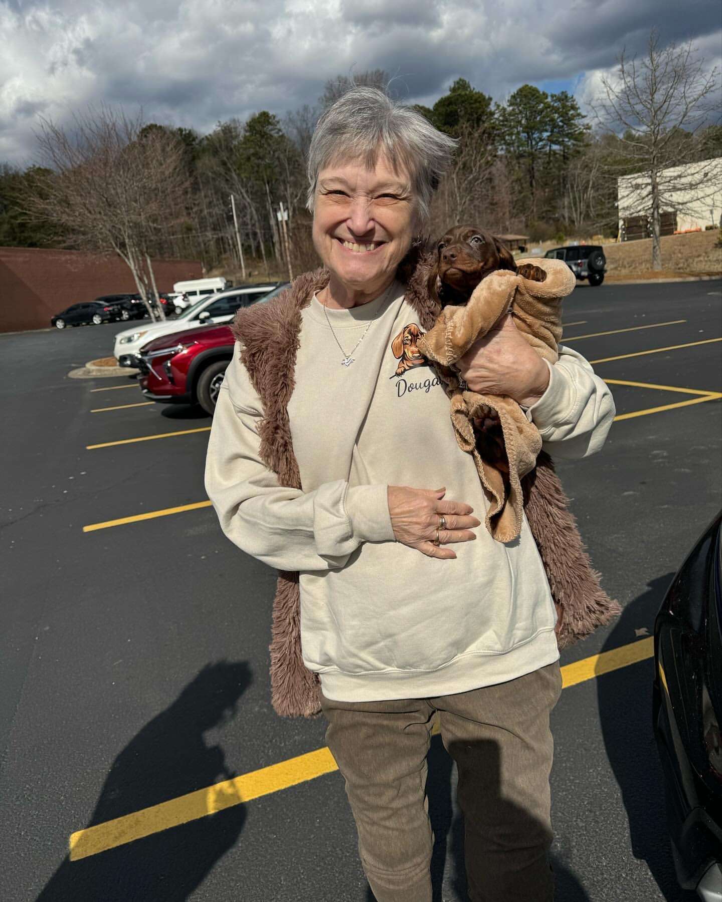 Happy family with their Dachshund puppy