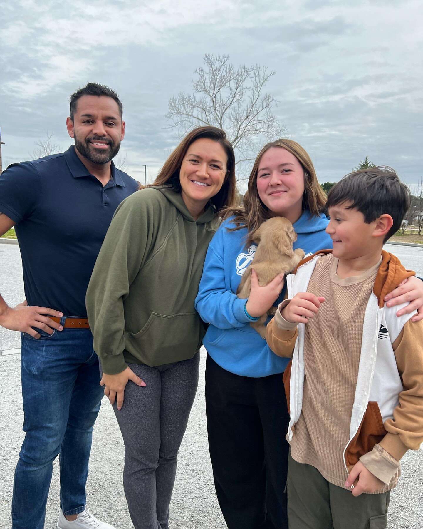Happy family with their Dachshund puppy