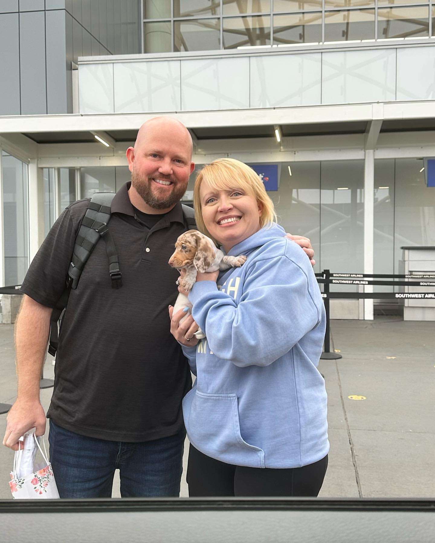 Happy family with their Dachshund puppy