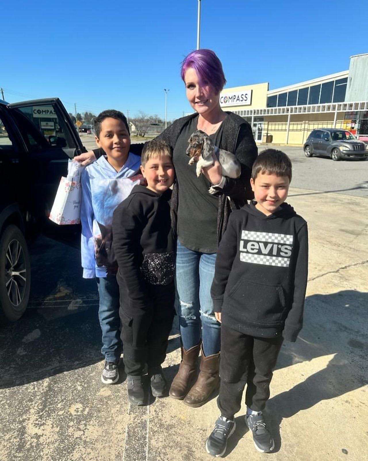 Happy family with their Dachshund puppy