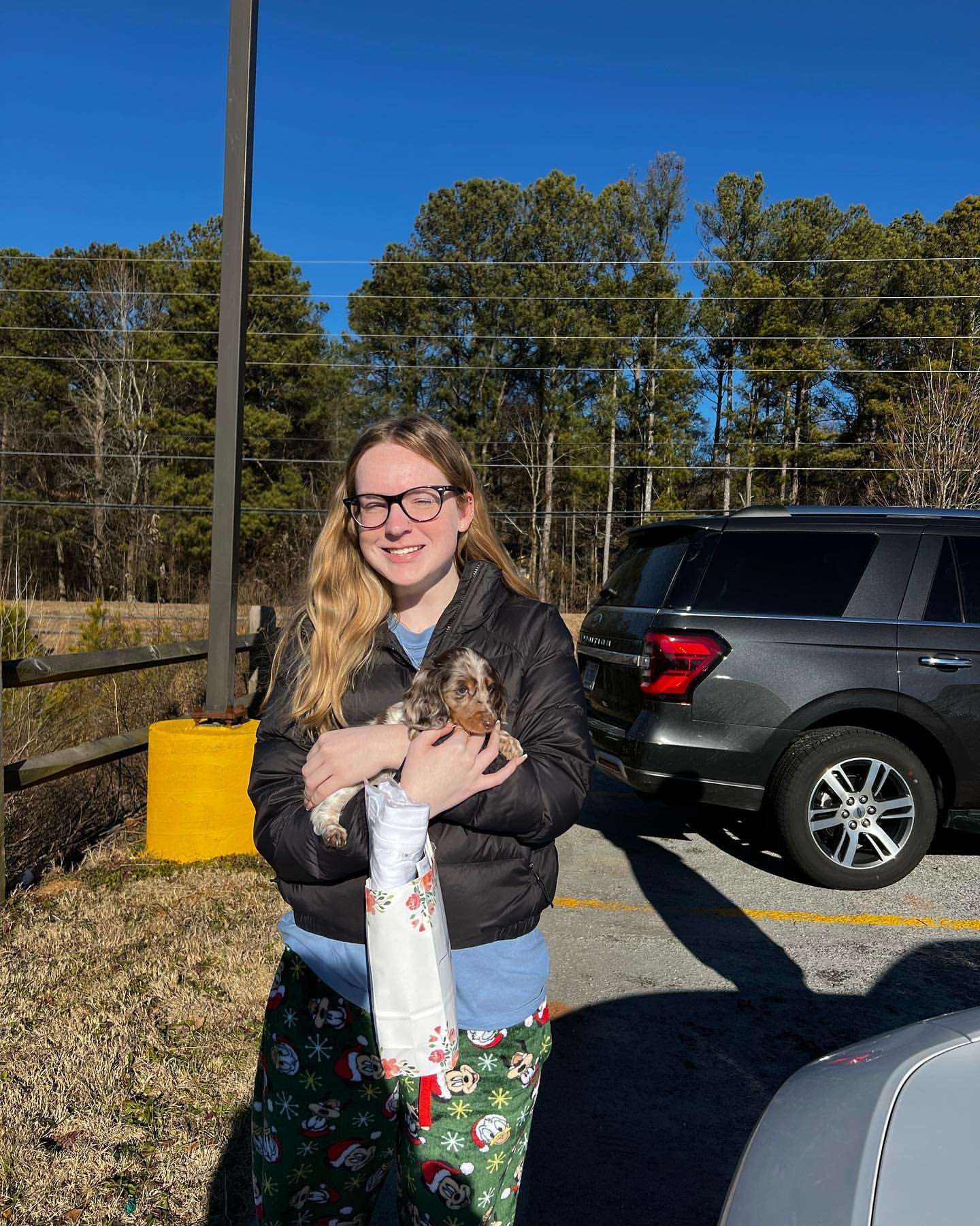 Happy family with their Dachshund puppy