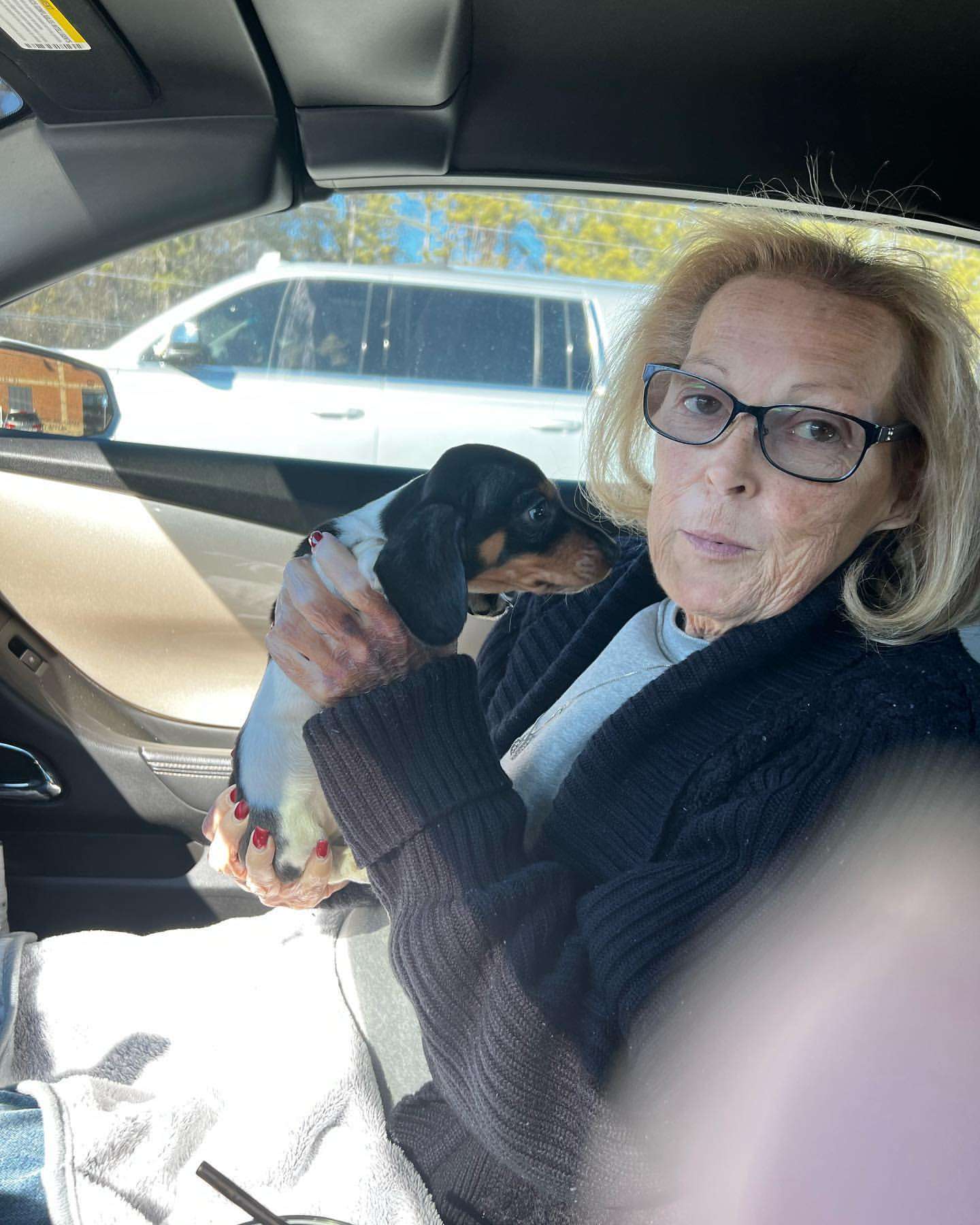 Happy family with their Dachshund puppy