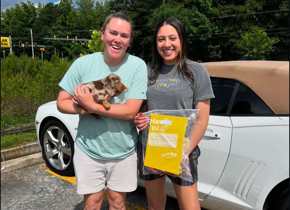 Happy family with their Dachshund puppy