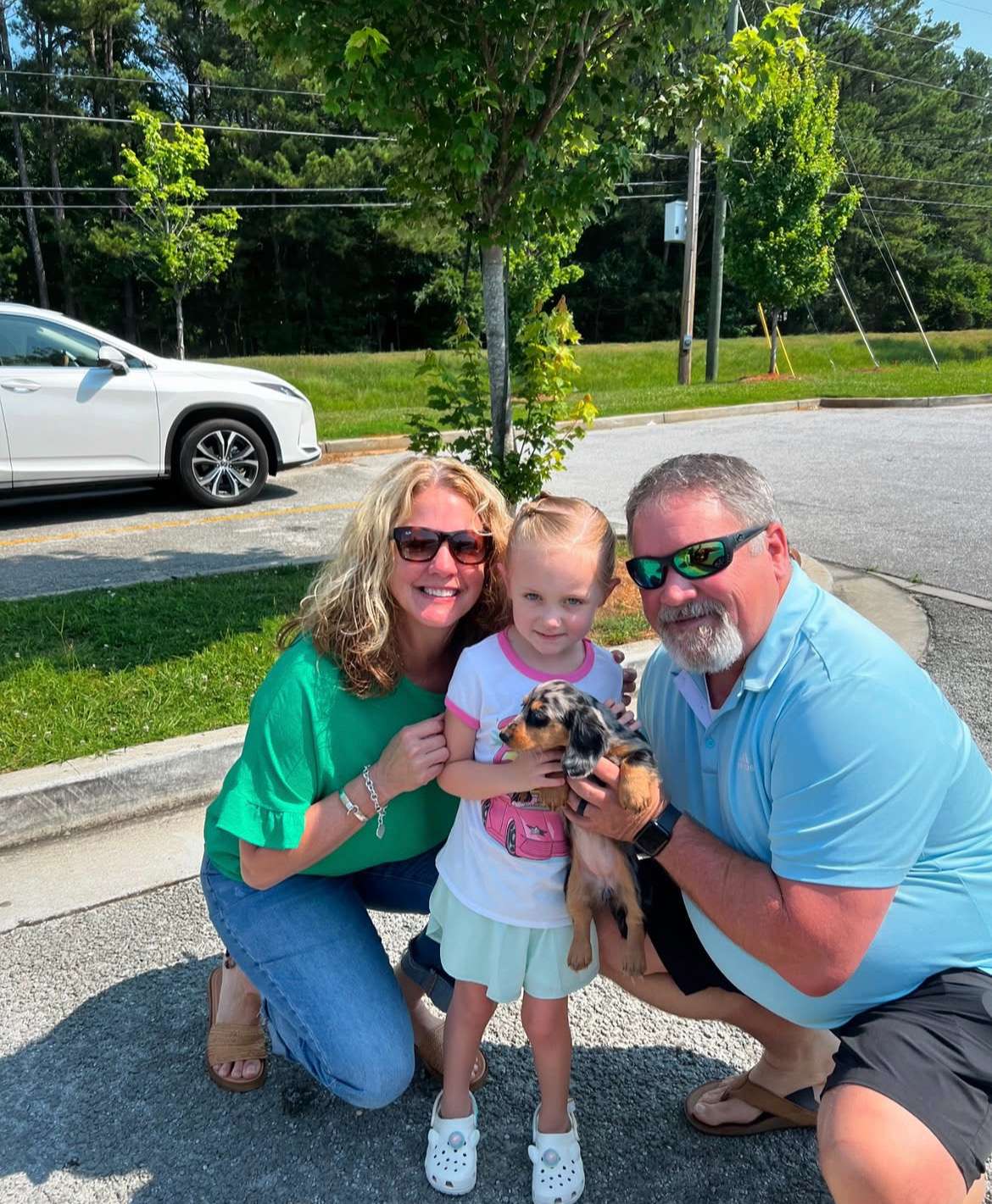 Happy family with their Dachshund puppy