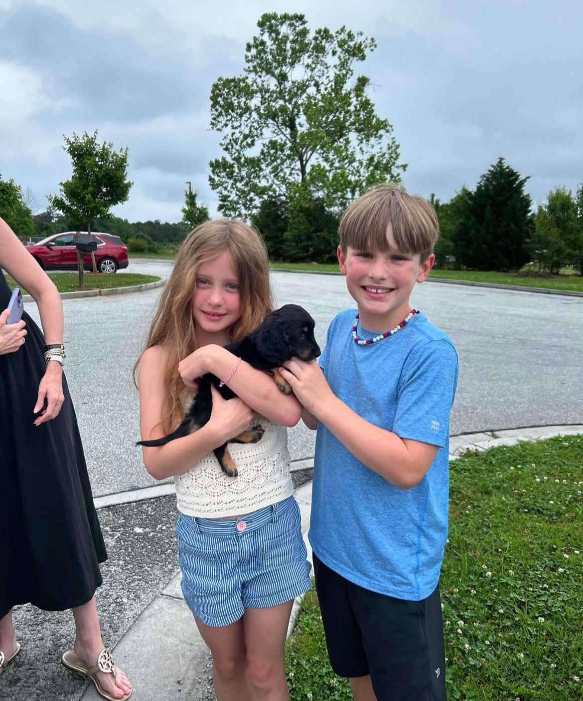 Happy family with their Dachshund puppy